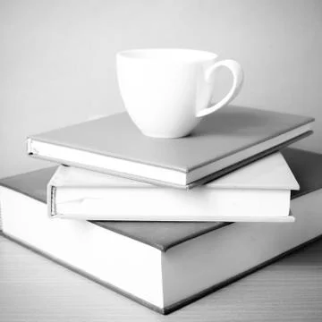 Stack of book with coffee cup black and white color tone style Stock Photos