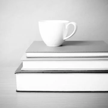 Stack of book with coffee cup black and white color tone style Stock Photos