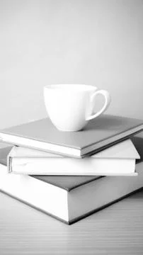 Stack of book with coffee cup black and white color tone style Stock Photos