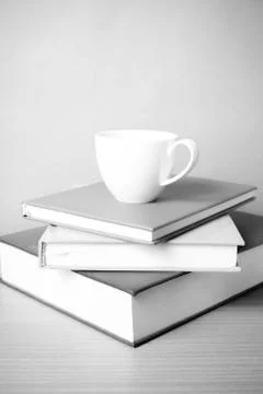 Stack of book with coffee cup black and white color tone style Stock Photos