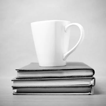 Stack of book with coffee mug black and white tone style Stock Photos