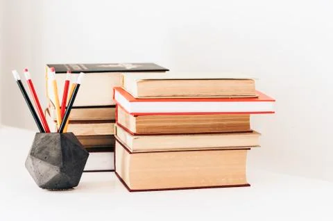 Stack of book education concept background, many books piles and pencils in c Stock Photos