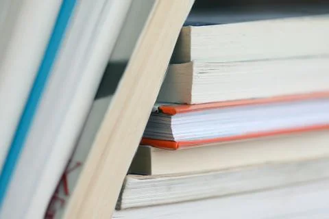 A stack of book leaning on a pile of books, artistically arranged, beautiful Stock Photos