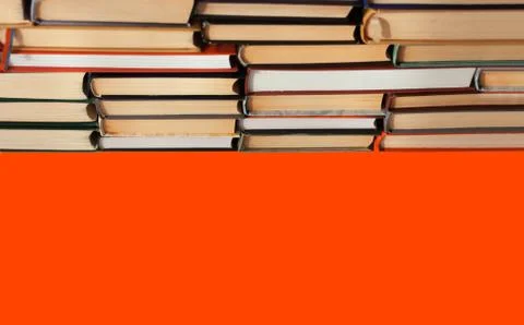 Stack of book on red orange lush lava background, education concept, back to  Stock Photos