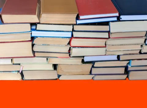 Stack of book on red orange lush lava background, education concept, back to  Stock Photos