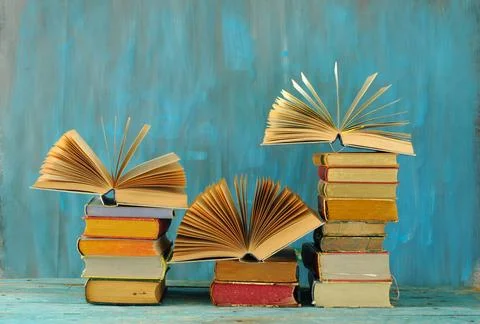 Stack of books with 3 open books, international book fair, reading, learnin.. Stock Photos
