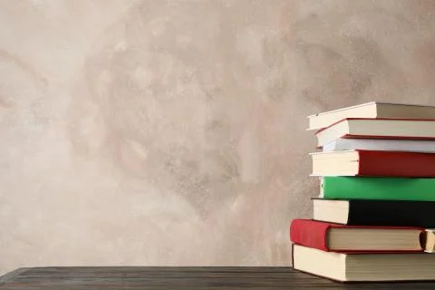 Stack of books against brown background, space for text 写真素材