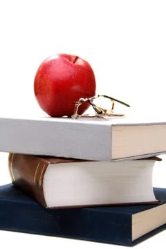 Stack of books and apple. Stock Photos