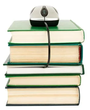Stack of books and computer mouse Foto stock