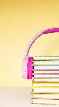 Stack of books and headphones on the table Stock Photos