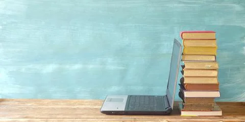 Stack of books and laptop computer,e-book reader.E-Learning,online education Stock Photos