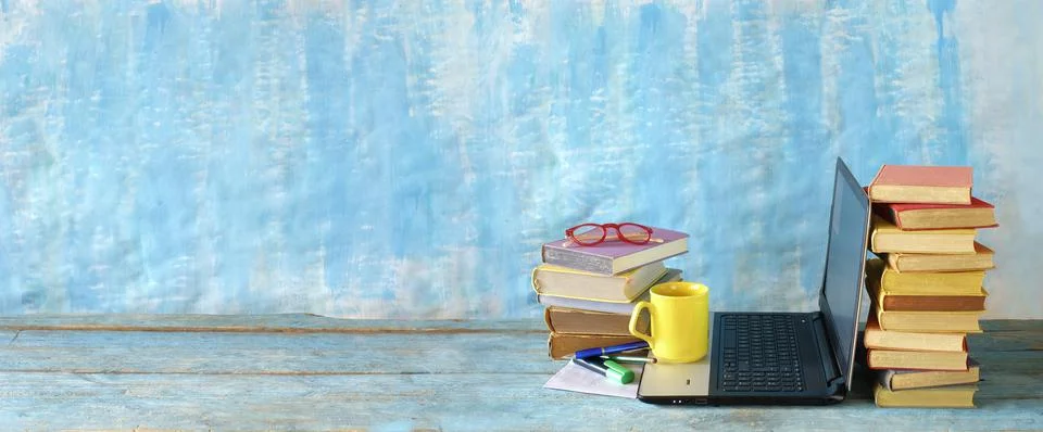 Stack of books and laptop computer,home office, homeschooling,reading,educate Stock Photos