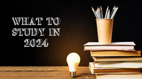 A stack of books and a light bulb Stock-Fotos