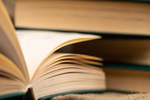 A stack of books and an open book on the table. Close-up, selective focus Stock Photos