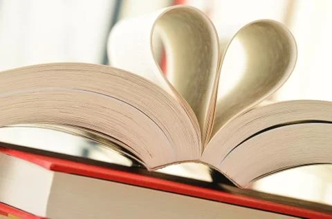 Stack of books and pages formed in a shape of heart Stock Photos