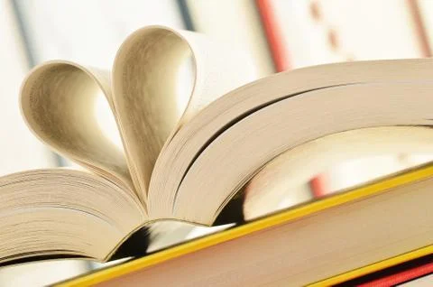 Stack of books and pages formed in a shape of heart Stock Photos