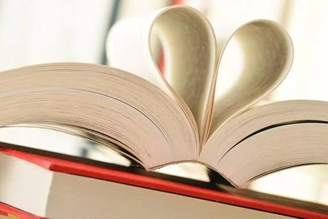 Stack of books and pages formed in a shape of heart Composition with stack... Stock Photos