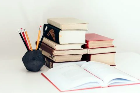 Stack of books and pencils in holder, education concept background, many book Stock Photos