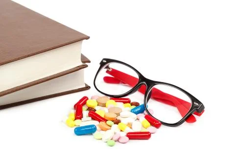 Stack of books and pills, capsules. Medicaments. Stock Photos