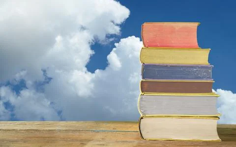Stack of books with beautiful clouds in the background free copy space, Stock Photos