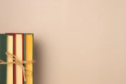 Stack of books on a beige background. Leisure concept, reading a book. Copy s Stock Photos