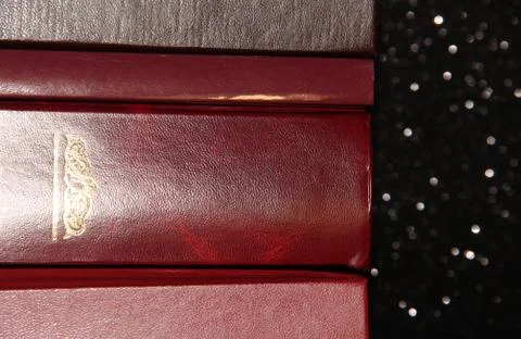 A stack of books on a black background. Many colorful books. Books in a long  写真素材