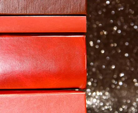 A stack of books on a black background. Many colorful books. Books in a long  스톡 사진