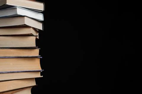 A stack of books on a black background. Stock Photos
