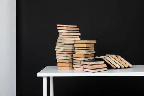 Stack of books on a black background science education culture training Stock Photos