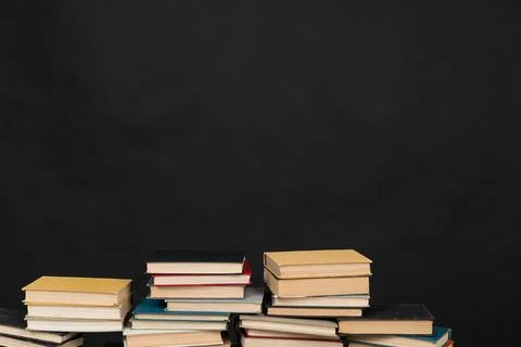 Stack of books on a black background science learning library education Foto stock