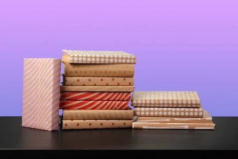 Stack of books on black wooden table Stock Photos