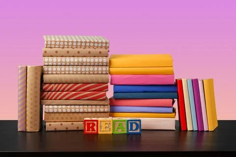 Stack of books on black wooden table Stock Photos