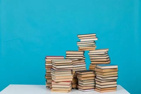 Stack of books on a blue background Library Education Stock Photos