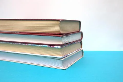 Stack of books on blue table Stock Photos