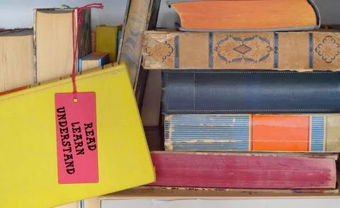 Stack of books in a bookshelf with slogan read learn understand.Back to sch.. Stock Photos