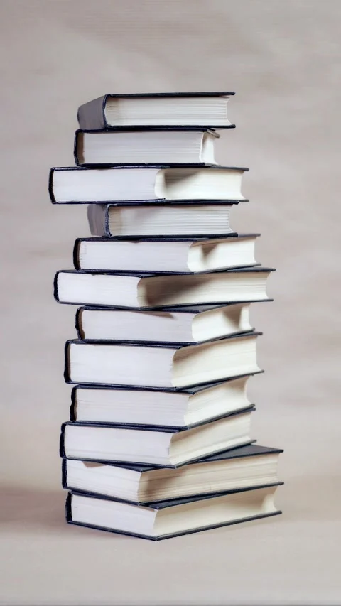 Stack of books on brown background. Stop motion animation Stock Footage 303146496
