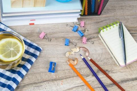 A stack of books, a clock, wooden cubes in the shape of a pyramid, next to th Stock Photos
