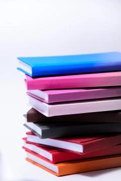 Stack of books close up on the side on a white background Photos