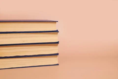 A stack of books on a colored background. Copy space Foto stock