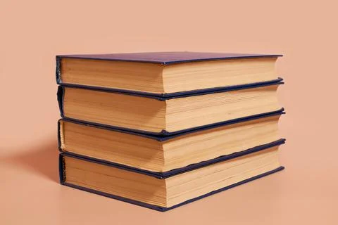 A stack of books on a colored background. Copy space Stock Photos