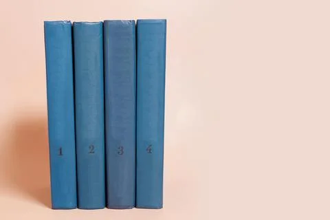 A stack of books on a colored background. Space for text Stock Photos
