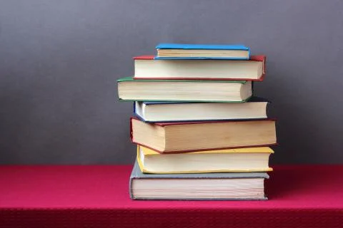 Stack of books in the colored cover on the table. Stock-Fotos