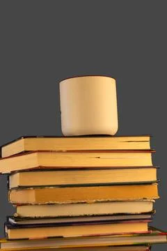 Stack of books with cup of coffee on top Stock Photos