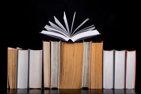 A stack of books on the desk. Old extensive literary publications. Stock Photos