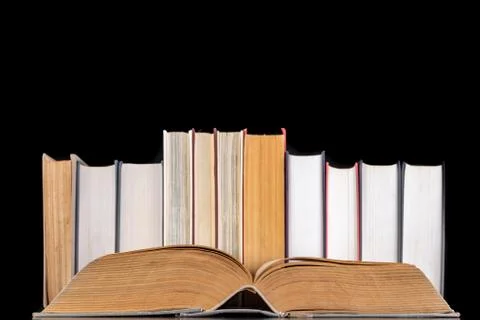 A stack of books on the desk. Old extensive literary publications. Stock Photos