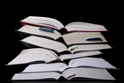 A stack of books on the desk. Old extensive literary publications. Stock Photos