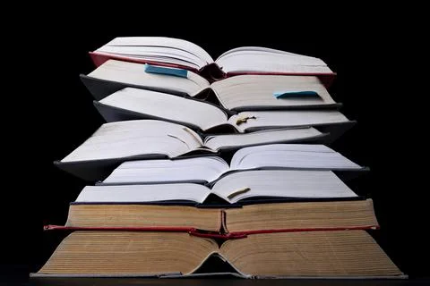 A stack of books on the desk. Old extensive literary publications. Stock Photos