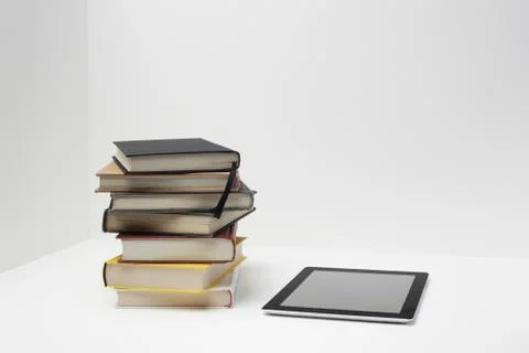 Stack of books with digital tablet Stock Photos