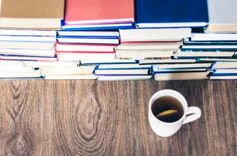 Stack of books education background, many books piles and cup of tea with lem 스톡 사진