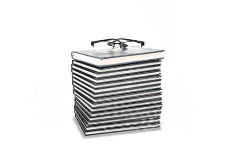 Stack of books with eyeglasses on the white background Stock Photos